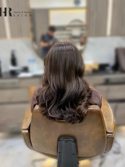 The "after" shot, showing a rich, warm brown global color. The hair looks healthy, shiny, and evenly colored.