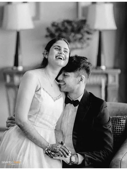 A burst of shared laughter. This black and white photo captures a moment of genuine happiness and ease between them, a break from the formal poses.