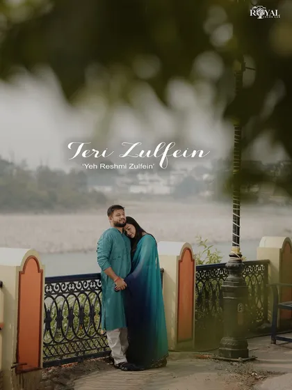 A romantic portrait of a couple embracing by a lamppost overlooking the river, with a soft, dreamy edit.