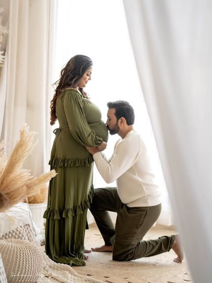 A kiss for the baby. This classic and tender pose shows the dad-to-be's love and excitement for their little one, creating a truly touching memory.