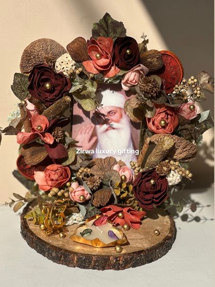 This Guru Nanak Dev Ji darbar features a rich, earthy color palette with maroon and brown florals on a wooden base, creating a warm and reverent spiritual centerpiece.