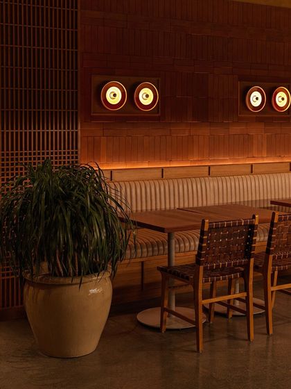 As evening sets in, the custom lighting at Biergarten creates a warm, ambient glow. The design highlights the natural textures of the wood and terracotta, transforming the space into a cozy retreat.