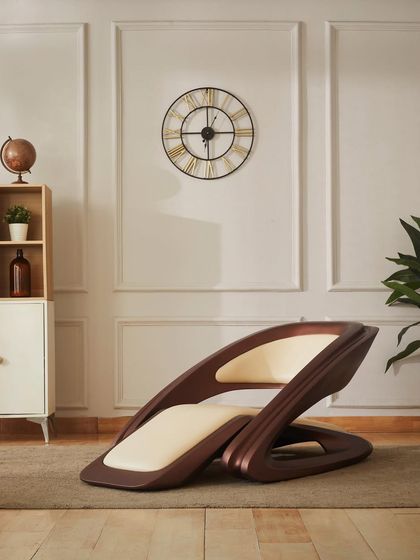 A close-up of the chair's elegant curves and wood-finish frame. This piece is designed to be a statement of style and comfort in any contemporary space.