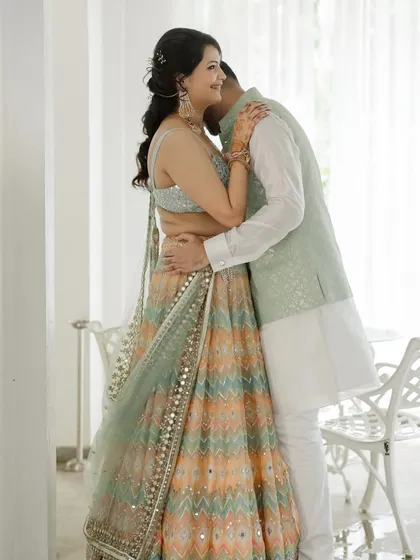 A warm embrace. This shot captures a moment of pure love and comfort between the couple, styled in soft, coordinating outfits that enhance the gentle and romantic mood.