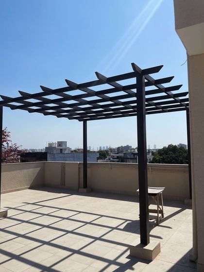 A slightly different angle of the basic pergola frame, showing how the open rafter design will create dynamic shadow patterns on the terrace floor once the project is complete.