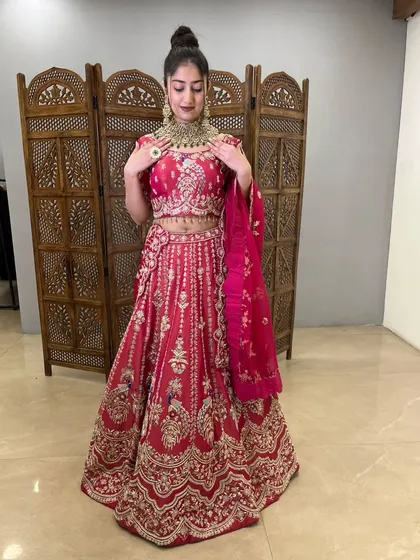 The detailed work on this pink lehenga is absolutely breathtaking, perfect for a special occasion.