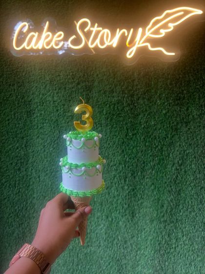 Another shot of the cone cake, held up against my 'Cake Story' neon sign.