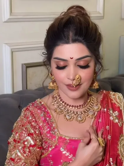 A candid moment of the bride looking down, showing the flawless application of eyeshadow and lashes.