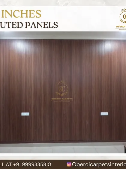 This 12-inch wide fluted panel in a dark wood finish covers an entire wall, providing a simple yet powerful backdrop for a bedroom or living area.
