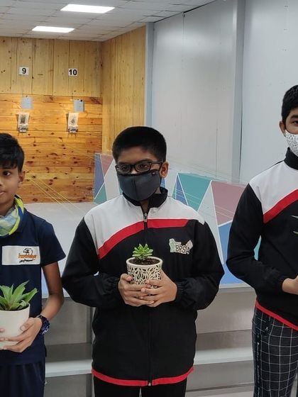 Our junior shooters holding their plant gifts after a friendly competition at the academy.
