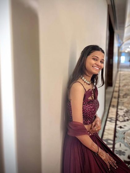 A candid shot showing the joy and confidence that comes from wearing an outfit you love. This maroon gown is both elegant and easy to wear.