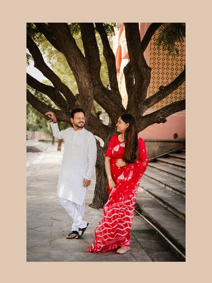 A candid moment under a tree near Patrika Gate, capturing a natural and relaxed interaction between the couple.