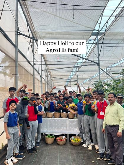 A joyful group of students celebrates Holi at our farm, holding up baskets of colorful, freshly harvested produce. It's a beautiful reminder to live as vibrantly as nature.