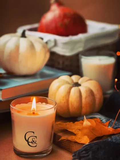 Embrace the cozy feeling of autumn with a warm, scented candle. This jar candle, featuring my C&C logo, is perfect for the fall season, surrounded by pumpkins and autumn leaves to create a comforting atmosphere.
