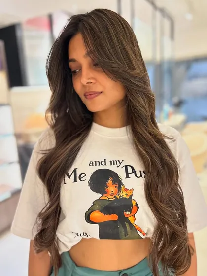 A warm mocha and beige balayage blend paired with long, flowing face-framing layers. This style is perfect for adding shape and dimension to long hair.