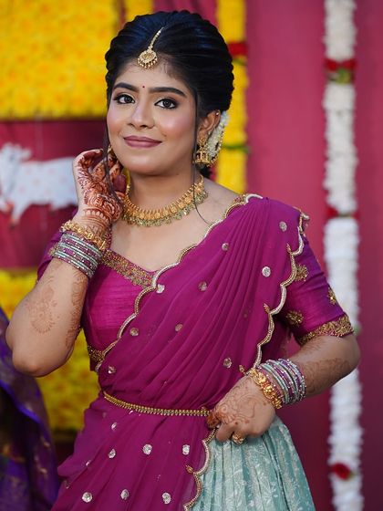 Nothing makes me happier than dressing sisters for their special moments. I designed these matching turquoise and purple Langa Voni outfits for a half saree function, ensuring they both looked coordinated yet unique.