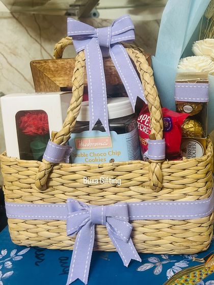 A close-up of the lilac-themed birthday hamper, showing the neatly tied ribbons and the variety of treats inside.