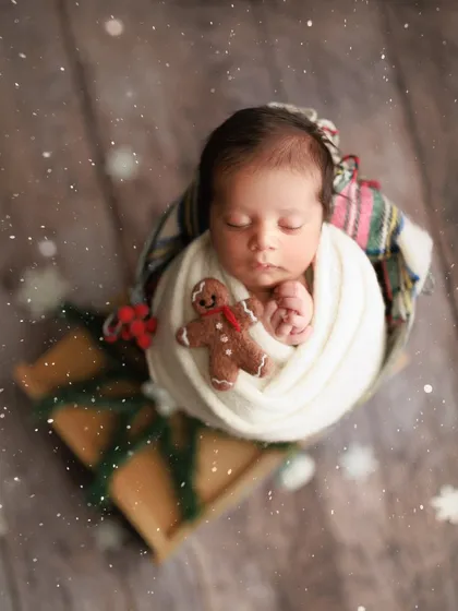 Baby's first Christmas. I love creating festive holiday-themed shots. This little one is wrapped up like a present with a tiny gingerbread man, ready for the most wonderful time of the year.