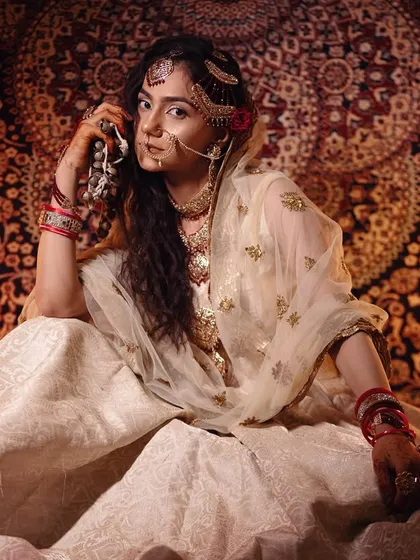 This seated portrait showcases the full regal effect of the traditional makeup and styling created by my students.