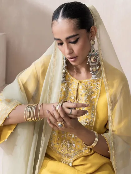 A detailed shot focusing on the accessories for the yellow kurta set. I chose heavy, traditional silver earrings and stacked bangles to create a beautiful contrast with the modern silhouette of the outfit.