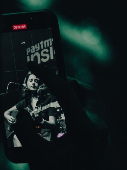 A fan capturing the moment on their phone. It's a surreal feeling to see my performance through your eyes.