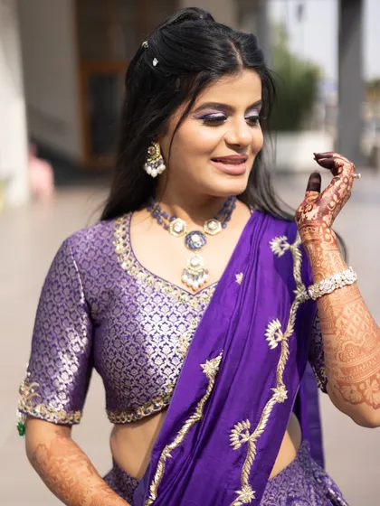 My bride ready for her Haldi ceremony in a stunning purple outfit. The makeup is vibrant with a pop of purple on the eyes to match her lehenga.