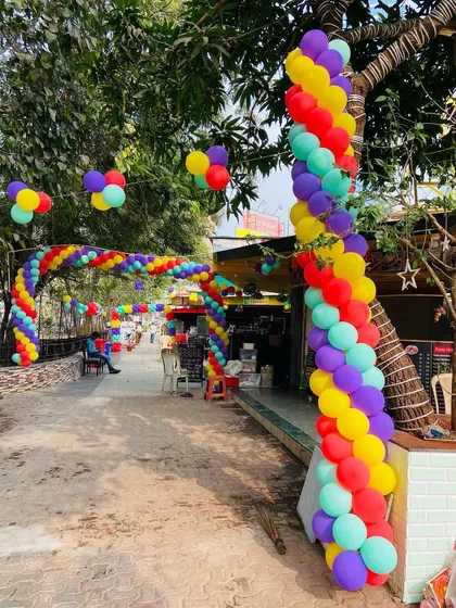 Another view of the extensive outdoor balloon archway, wrapping around trees and creating a festive path.