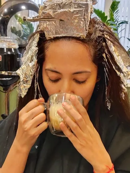 A moment of relaxation during a colouring session. Enjoying a warm coffee while the foils are in is part of the luxurious salon experience I offer.