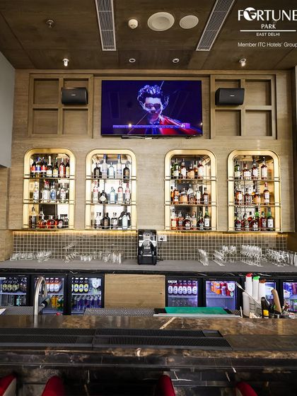 The heart of Neptune: our fully stocked bar with its elegant arched shelves and modern backlighting.