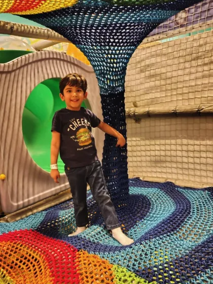 Exploring the colorful, multi-level rainbow net climber is a favorite activity for our adventurous guests.