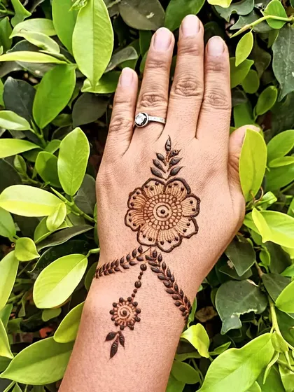 A simple and beautiful floral design on the back of the hand, perfect for someone who wants a quick, elegant touch of henna.