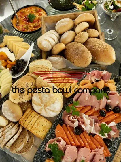 Our modern grazing tables are perfect for networking events. This spread features a curated selection of artisanal breads, imported cheeses, cold cuts, and fresh dips, designed to encourage interaction and conversation.