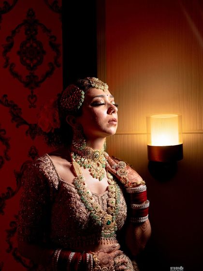 Another artistic shot from my wedding album. The warm lighting accentuates the bronze and gold tones in my makeup, creating a dramatic and memorable bridal portrait.