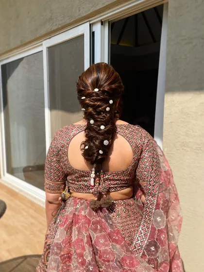 A bejeweled braid perfect for a sangeet or reception. The sparkling accessories woven through the hair catch the light beautifully, especially for an evening event.