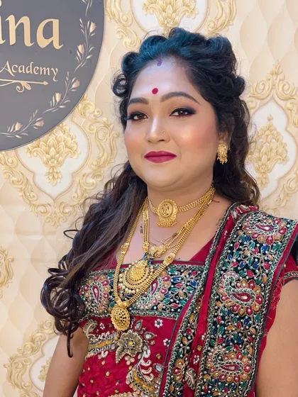 A mature client styled for a wedding. I created a look that is elegant and age-appropriate, with soft makeup, a red lip, and a simple half-up hairstyle.