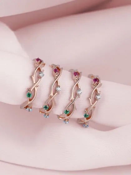 This stunning custom-made ring features a unique design of intertwining vines set with rubies, emeralds, and diamonds. Each handmade piece reflects your personal story, created with passion and precision.