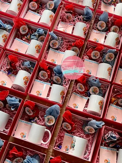 A full view of our Paw Patrol return favours, which we shipped to Kolkata. Each pink box was themed and filled with handmade chocolates, almond rocks, and a customised character mug.