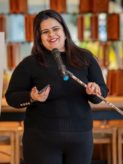 A performer's bright smile shows the joy of being heard. Our community is built on mutual respect and appreciation for every voice that graces our stage.