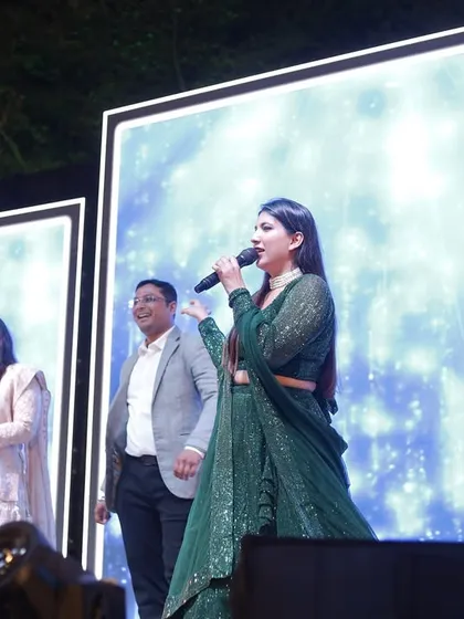 Interacting with the bride and groom's parents on stage. These personal interactions are what make a wedding celebration truly special and memorable.
