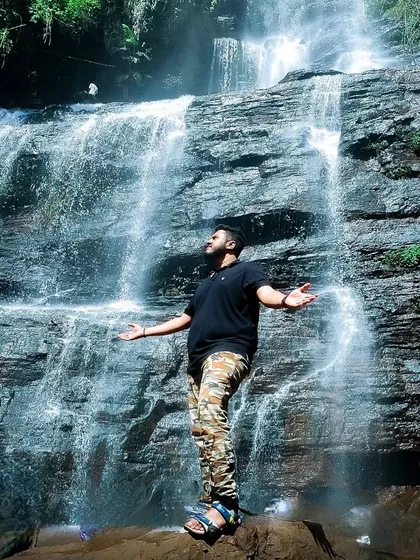 A solo shot of me feeling the power of a waterfall in Chikmagalur, a moment of connection with nature.