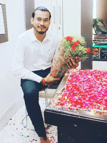 A moment of celebration in the office, surrounded by flowers.