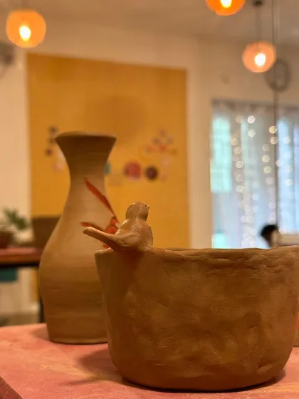 A student's creation featuring a small bird perched on the rim of a bowl. It’s these personal touches that make each handmade piece so special.