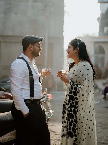 Sometimes the best moments happen over a simple cup of chai. This candid shot from a retro-themed pre-wedding shoot in Pune captures a sweet, everyday kind of love.