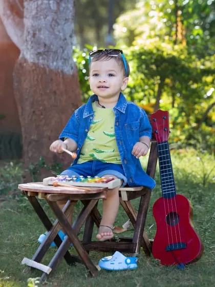 This cool little dude is enjoying the sunshine and making music.