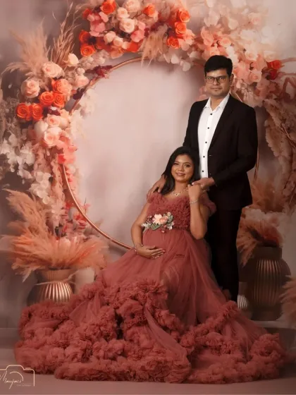 A beautiful portrait of an expecting couple in the boho ring setup. The rich, earthy tones of the gown and flowers create a warm and inviting feel.