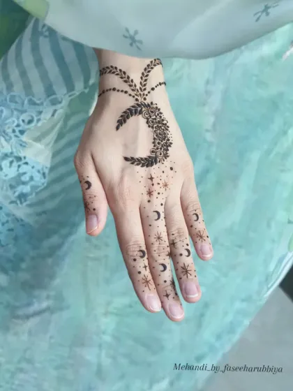 A whimsical moon and stars design, scattering across the fingers for a magical look.