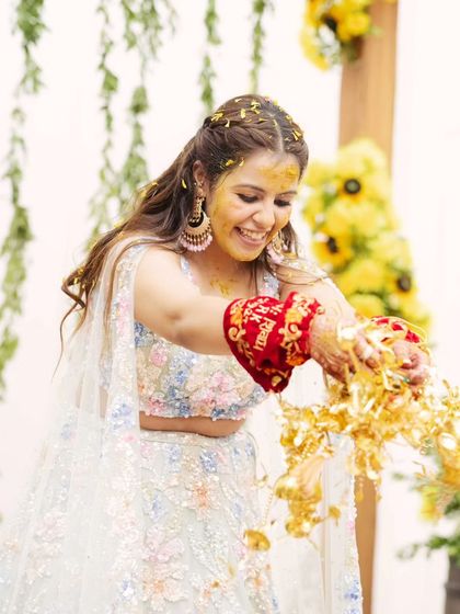 The traditional kalire ceremony during the Haldi event. The bride looks beautiful and ready for the rituals.