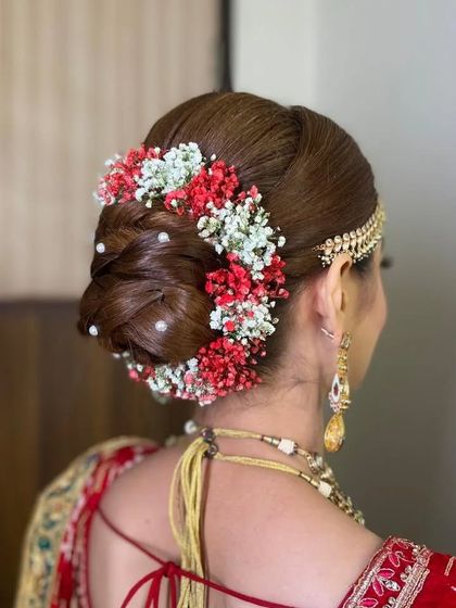 A side view of the colorful floral bun, showing how the flowers create a beautiful crown effect. This is a perfect hairstyle for a daytime wedding.