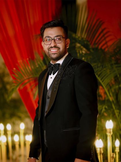 A classic portrait of the groom, Shivam, looking sharp in his tuxedo for the engagement party.