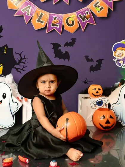 A more serious witch, contemplating her next spell. The spooky backdrop with ghosts and pumpkins sets the perfect Halloween mood.